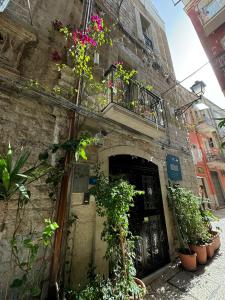 a building with a door and a balcony with flowers at PALAZZO NICOLAUS del BORGO ANTICO in Bari