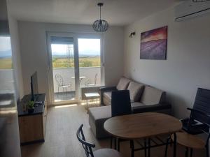 a living room with a couch and a table at Apartment Rosa in Varaždin +7 photos