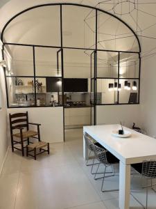 a kitchen with a table and chairs in a room at Antica Foligno - Novellis de coarazze in Foligno