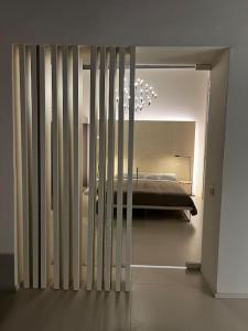 a view of a bedroom with a bed through a glass door at Antica Foligno - Novellis de coarazze in Foligno +2 photos