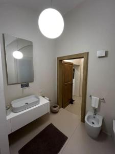 a bathroom with a toilet and a sink and a mirror at Antica Foligno - Novellis de coarazze in Foligno