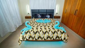 a bedroom with a bed with blue swans on it at Luxury Sky Blue in Jarabacoa