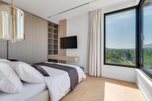 a bedroom with a bed and a large window at NEW Luxury villa I infinity pool in Starigrad-Paklenica +53 photos