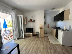 a small kitchen with a refrigerator and a table at Apartments Rotim, Mljet, Sutmiholjska in Babino Polje +32 photos