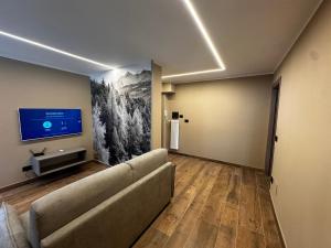 Et tv og/eller underholdning på Aosta Center Holidays Apartments Ski & Bike Box