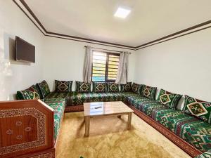 a living room with a couch and a table at Cabane Ouirgane in Aït Zat