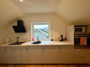 a kitchen with a sink and a window at Loft Apartment in Stranda