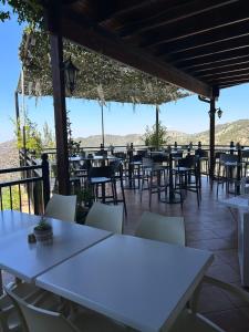 a row of tables and chairs on a patio at Two Flowers Hotel in Pedoulas