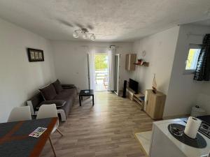 a living room with a couch and a table at Apartments Rotim, Mljet, Sutmiholjska in Babino Polje