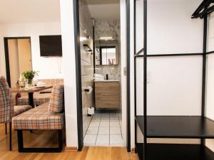 a living room with a kitchen and a dining room at Prost in Hopfgarten im Brixental +14 photos