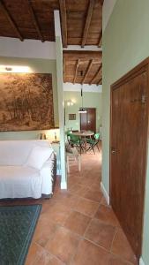 a bedroom with a bed and a dining room with a table at Suite Farnese Le Rondini - Gioiello nel cuore di Caprarola in Caprarola