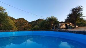 a large blue swimming pool in front of a house at Drop of Heaven in Katokhórion