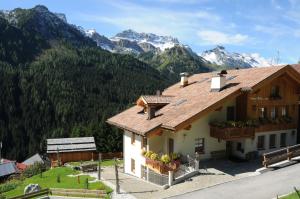 a building with mountains in the background at Design Chalet Zirm - check-in at Olympia Hotel in Varda