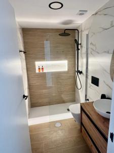 a bathroom with a shower and a toilet and a sink at Apartamentos Perseo Albir in Albir +20 photos