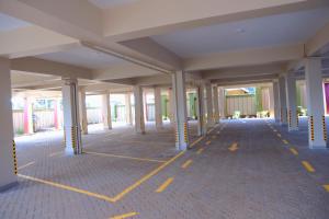 an empty hallway of a building with columns at Daisy's Apartments in Bwebajja