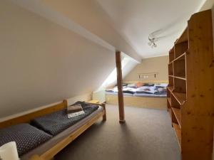 a bedroom with two beds and a bunk bed at Chalupa U brouka in Nová Bystřice +35 photos