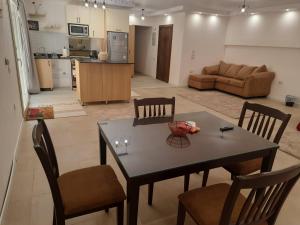 a kitchen and a living room with a table and chairs at New Cairo Zoé in Cairo +38 photos