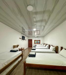 A bed or beds in a room at Buritaca House