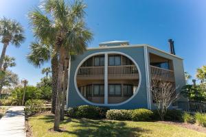 a house with a round window and palm trees at Beachfront Gem Core of St Augustine in Saint Augustine