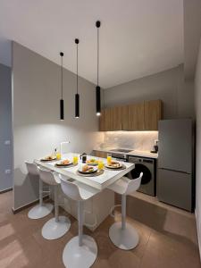 a kitchen with a table with plates of food on it at Modern Living Kefalonia in Lakíthra