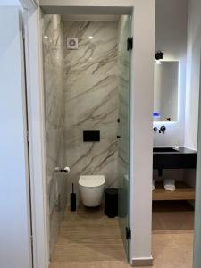 a bathroom with a toilet and a sink at Modern Living Kefalonia in Lakíthra