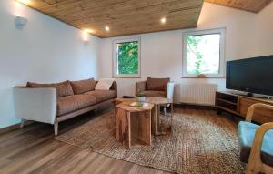a living room with a couch and a tv at Lovely Home In Sonlez With Sauna in Sonlez