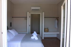a bedroom with two beds with towels on them at Modern Living Kefalonia in Lakíthra
