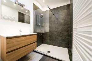 a bathroom with a shower and a sink at Maison villageoise Les Nobles Carrières in Frasnes +17 photos