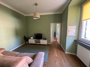 a living room with a couch and a television at Casa Nina Carignano in Genoa