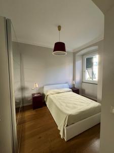 a bedroom with a large bed and a window at Casa Nina Carignano in Genoa