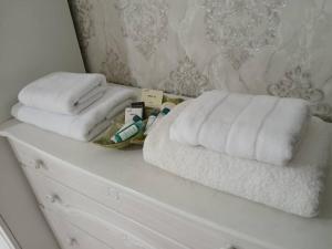 two towels on top of a white dresser at Elizabet guest house in Kerben