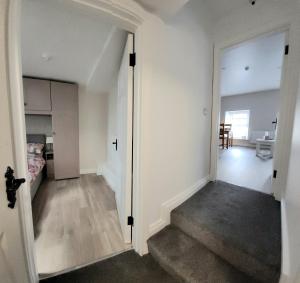 an empty room with a staircase leading to a bedroom at Modern town centre apartment in Tobercurry