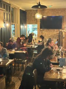 a group of people sitting at tables in a restaurant at The Brookmill in London
