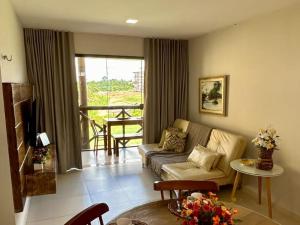 a living room with a couch and a table at Apbananeiras - Condomínio Sonhos da Serra in Bananeiras