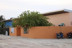 two motorcycles parked in front of a building at Samaik Orange in Hanimaadhoo