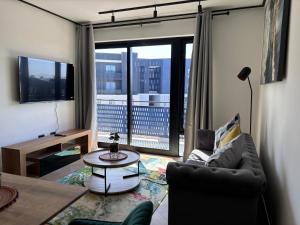 a living room with a couch and a table at BGS Luxury Accommodation-One bed-Cape Town in Cape Town