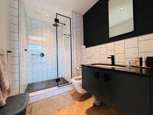 a bathroom with a shower and a toilet and a sink at BGS Luxury Accommodation-One bed-Cape Town in Cape Town +23 photos