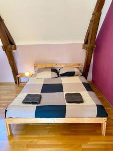 a bedroom with a bed with a checkered bedspread at Petit Launay - proche Rennes in Vezin-le-Coquet +30 photos
