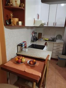 a kitchen with two bowls of fruit on a table at Parovic in Nevesinje +9 photos
