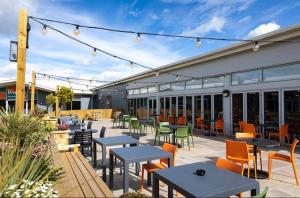 a patio with tables and chairs in a building at Coastal Caravan Holidays - Puffin 14 in Tunstall