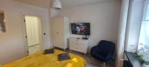 a bedroom with a bed and a chair and a dresser at Baltivia ADULTS ONLY in Świnoujście