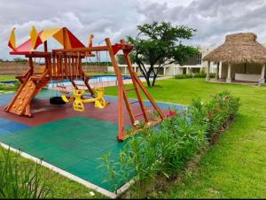 a playground in a yard next to a pool at CASABONITA II, pie alberca, AirAc in Xochitepec