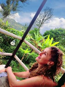 a woman sitting on a table looking up at the sky at Montelungo Cabañas Glamping in Chimbe +8 photos