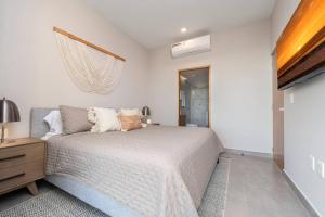 a bedroom with a bed and a dresser and a window at Best view rooftop with heated jacuzzi in Cabo San Lucas