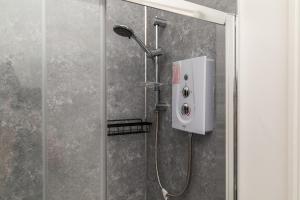a shower with a shower head in a bathroom at Dove Court Travel Lodge 1 - Ground Floor Ensuite in Bristol