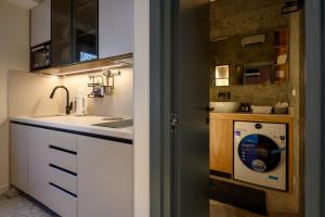 a kitchen with a washer and dryer in a room at Modular Central Studio in Kotor +12 photos