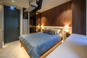 a bedroom with a large bed with blue sheets at Modular Central Studio in Kotor