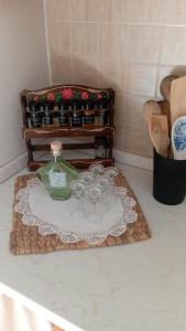 a group of cups and a bottle on a table at Apartman Rendulić in Ogulin +76 photos