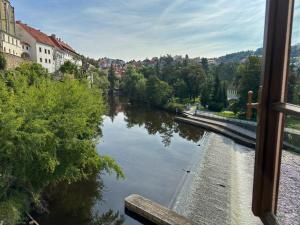 a view of a river from a train window at Boutique Hotel Barvírna in Český Krumlov