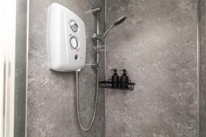a shower in a bathroom with a soap dispenser at Dove Court Travel Lodge 2 - First Floor Ensuite in Bristol
